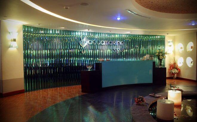 Quầy lễ tân của spa sang trọng với ánh sáng dịu và nến, tạo không gian thư giãn.