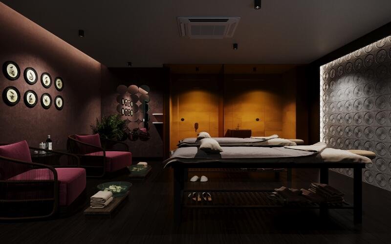 Phòng spa thư giãn với bàn massage, ánh sáng ấm áp và trang trí tường tinh tế, mang lại không gian thoải mái.