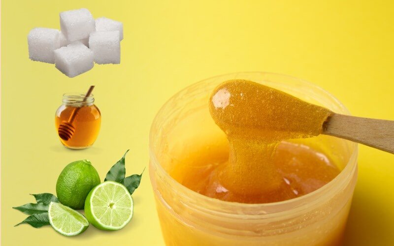 Lọ sáp tẩy lông với đường, mật ong, và chanh trên nền vàng.