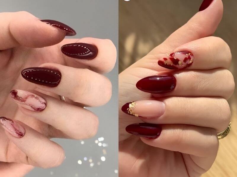 Hai bàn tay với móng tay sơn màu đỏ, một bên có họa tiết trang trí tinh tế.