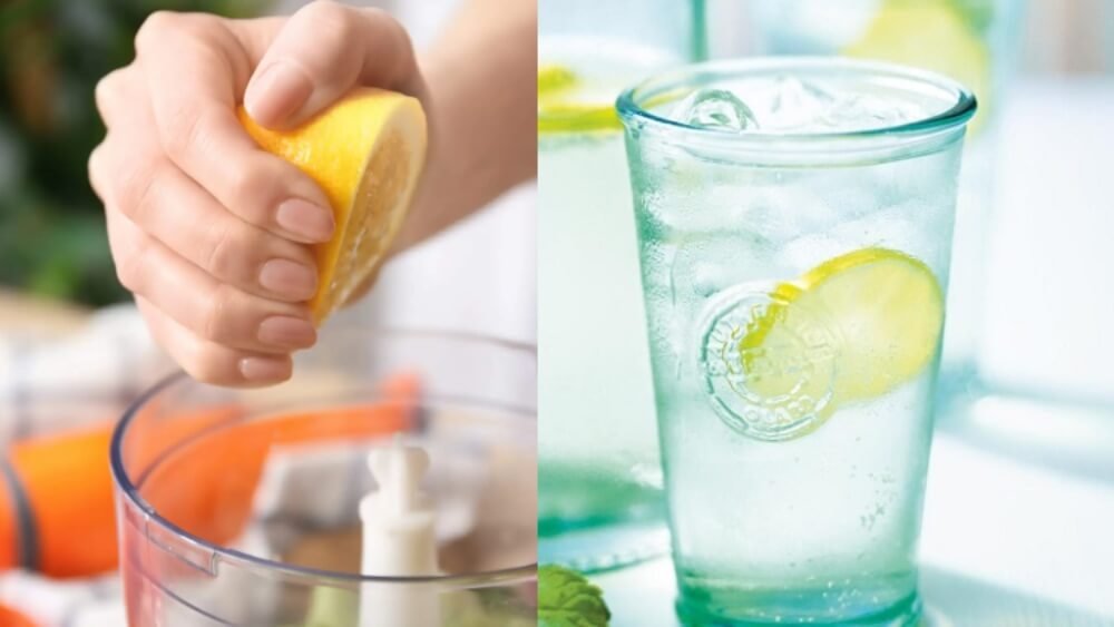 Bàn tay vắt chanh vào máy xay sinh tố; ly nước chanh đá mát lạnh bên cạnh.