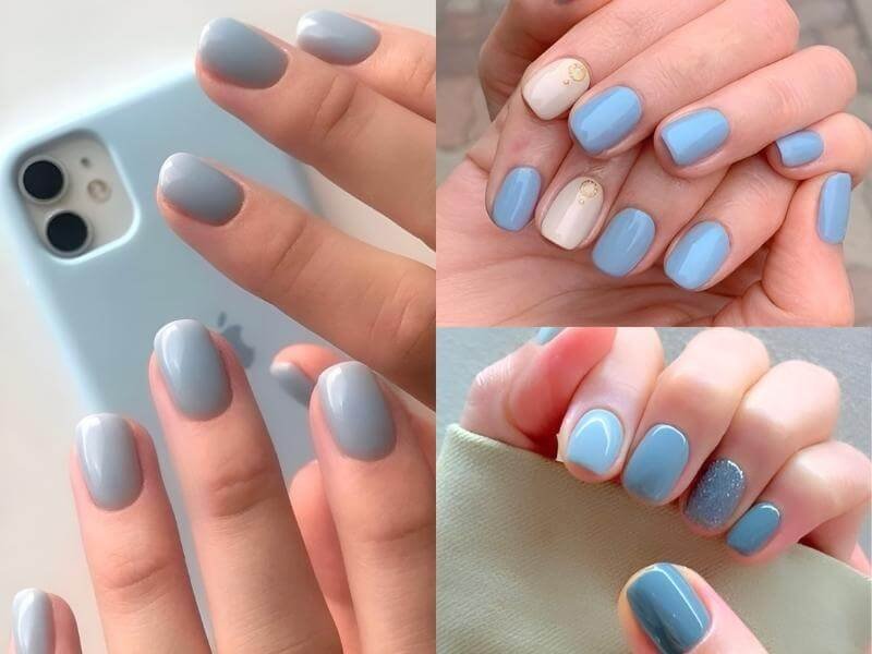 Bàn tay với móng tay sơn màu xanh da trời, một số móng có họa tiết và ánh kim loại.